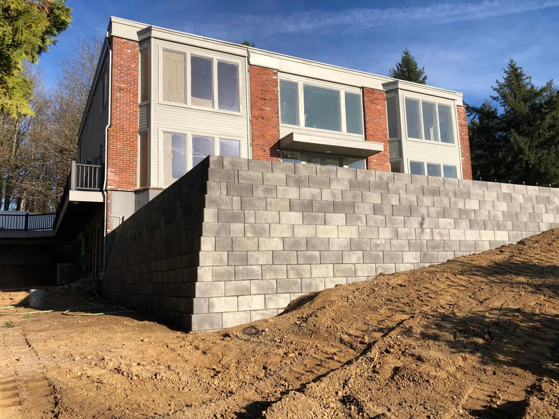 PacWest Retaining Walls crew and equipment on a commercial job site in Oregon