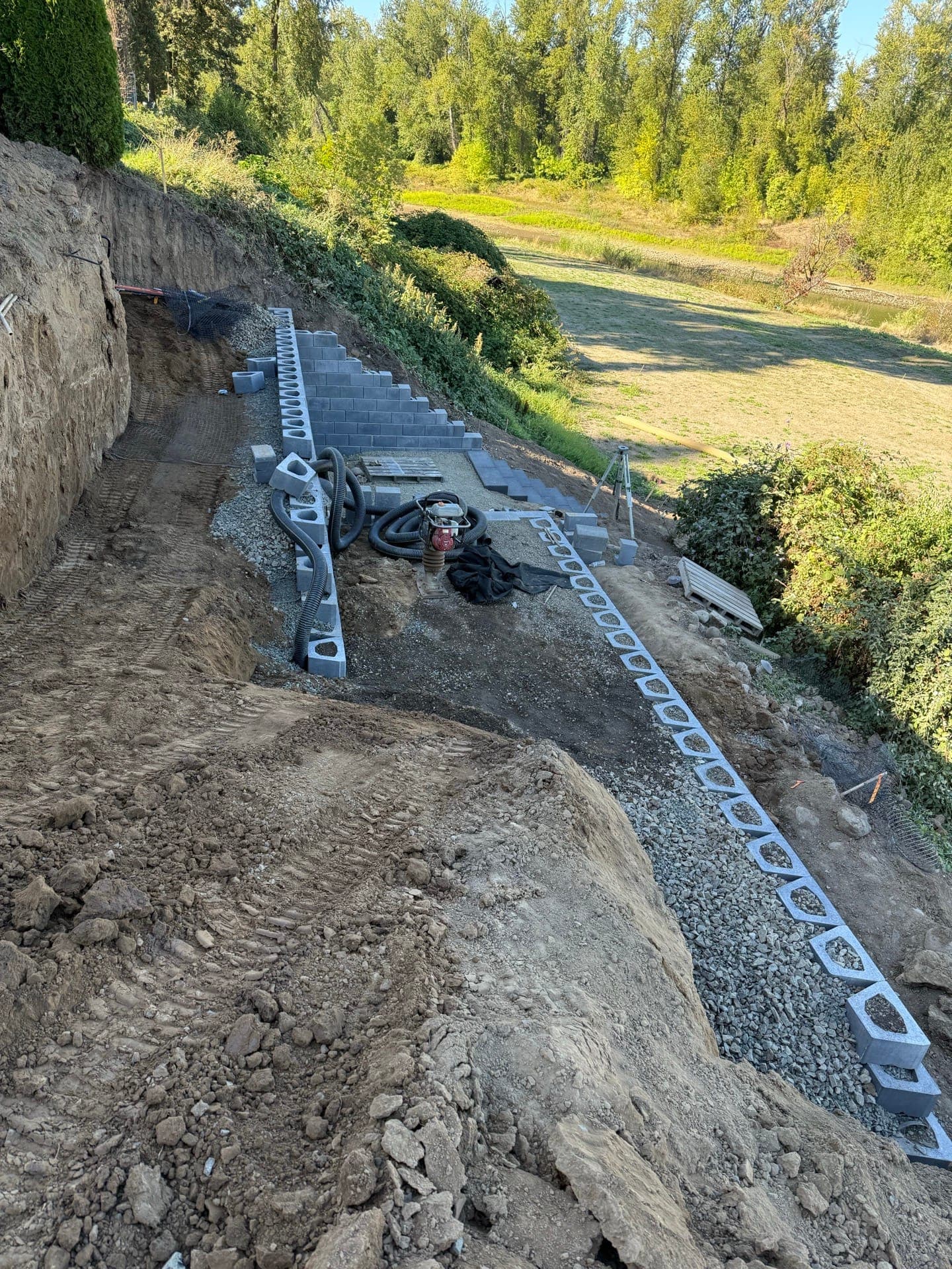 Segmental block retaining wall and handrail along a riverfront slope in West Linn, Oregon